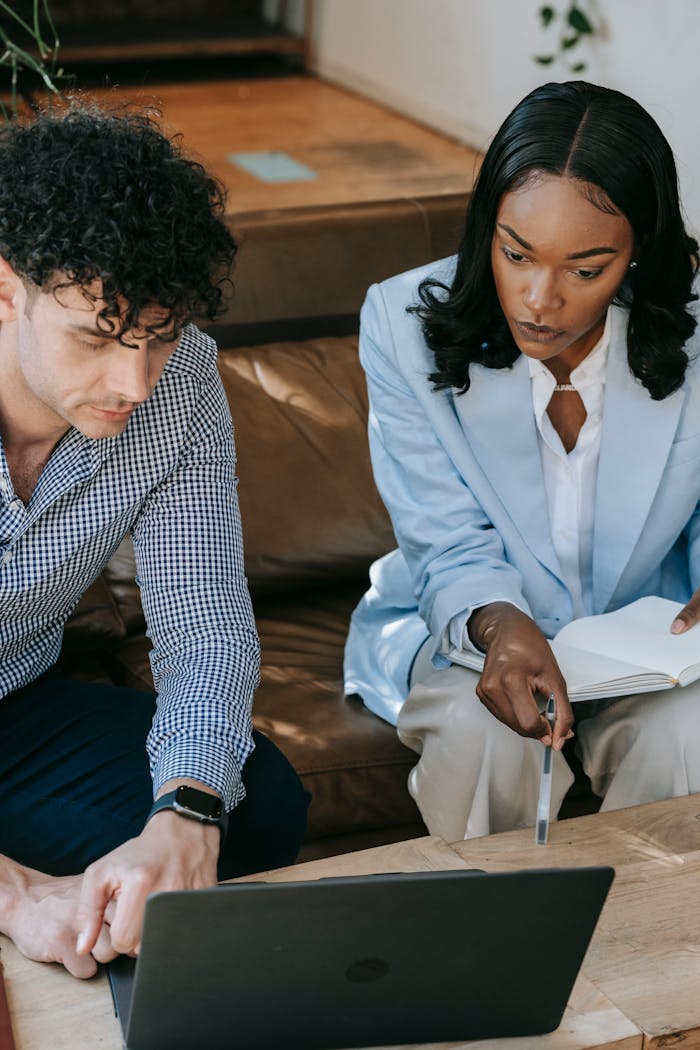Crafting Captivating Headlines: Your awesome post title goes here Two professionals working together closely on a laptop in a collaborative office setting.